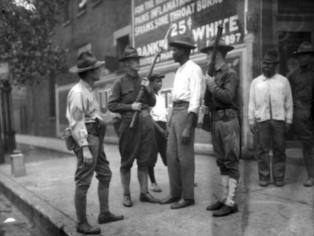 Soldiers stop an African American resident of Washington during the summer of 1919.